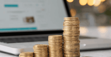 a-laptop-and-a-stack-of-coins